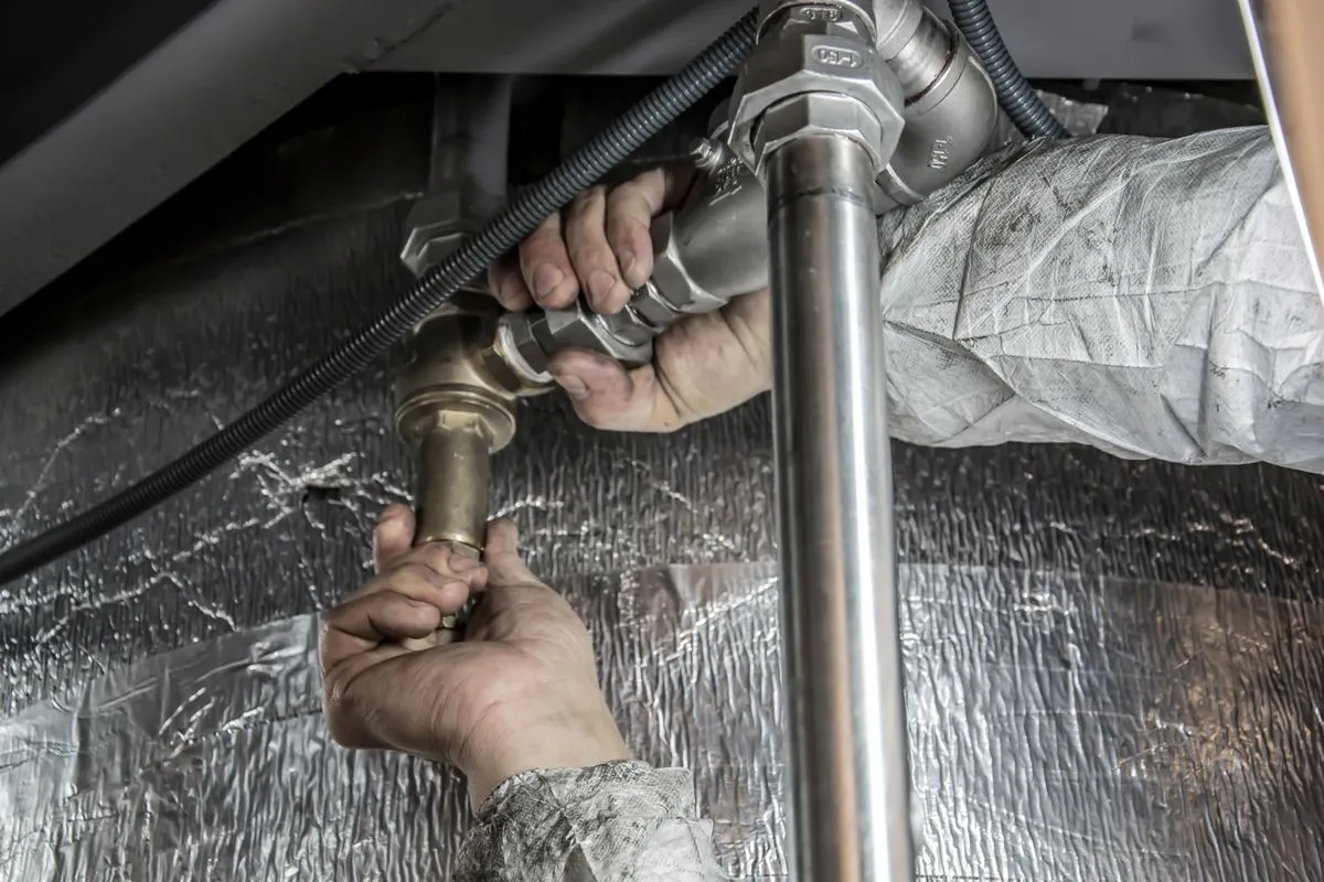 Emergency plumber repairing a burst pipe in a London home - 24/7 service